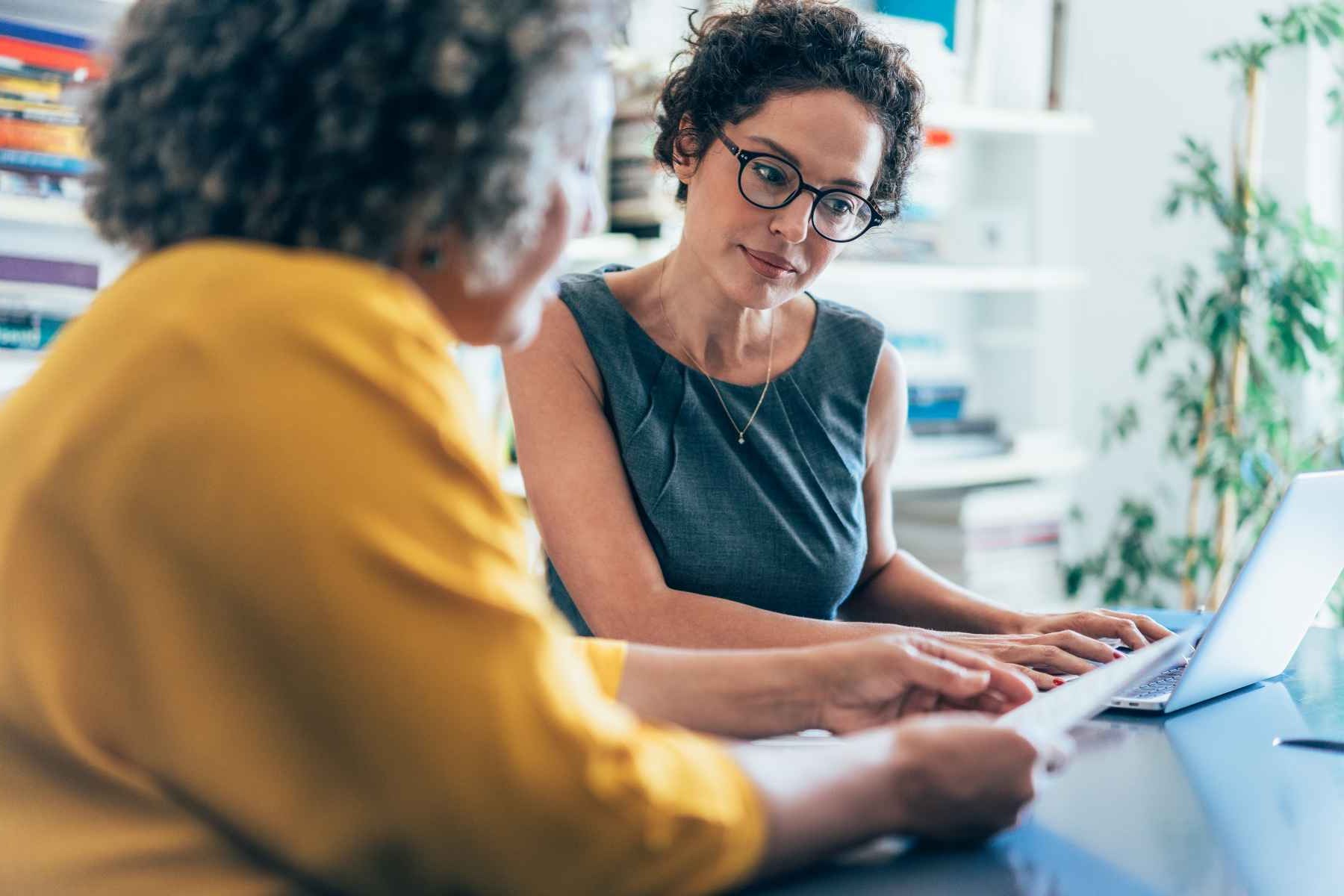 two office workers collaborating at desk