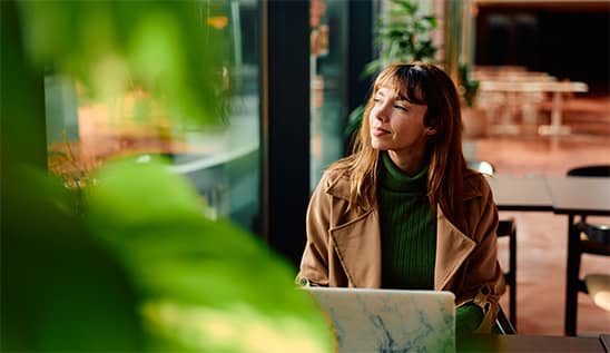 woman working at laptop in a cafe