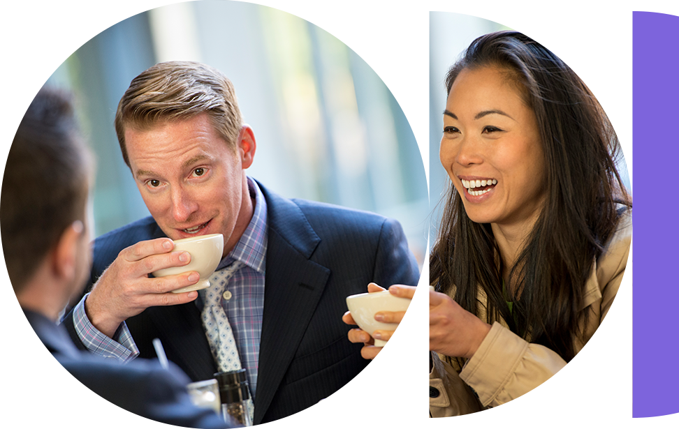 man and woman sat drinking coffee smiling